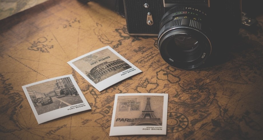 Camera and postcards on map