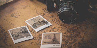 Camera and postcards on map