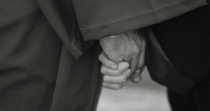 Elderly couple holding hands