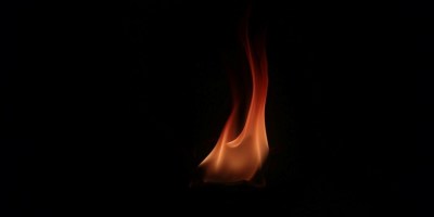 Picture of a single flame, illustration for short story "The Ember in Sarah Whitcomb" by Mariah Boland. Photo by Gaurav Diwan: https://www.pexels.com/photo/close-up-shot-of-flames-6652543/