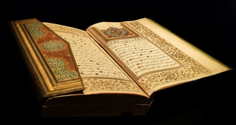 Photo by Enes Salih Gökçek: https://www.pexels.com/photo/open-decorative-book-with-arabic-script-against-a-black-background-13208790/