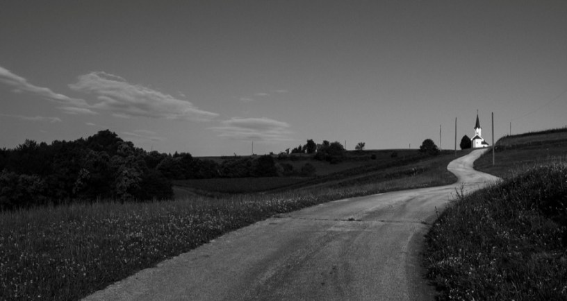 Road leading to white church building https://www.pexels.com/photo/tranquil-rural-road-leading-to-a-remote-church-34678668/
